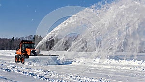 snow plow blower spraying snow into the air