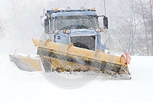 Snow plow cleaning street photo