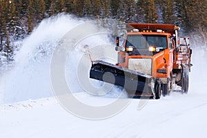 Snow plow clearing road after winter snow storm