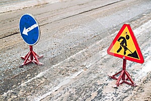 Snow-plow remove snow from the city street.Warning road sign.Winter service vehicle snow blower work.Cleaning snowy