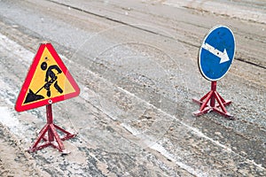 Snow-plow remove snow from the city street.Warning road sign.Winter service vehicle snow blower work.Cleaning snowy