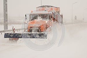 Snow plow removing snow from city road