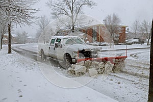 Snow plow removing snow from street.