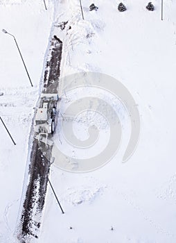 Snow plow tractor cleans the track in winter