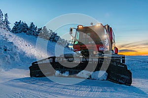 Snow plow tractor on a snowfield during winter