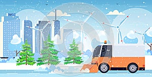 Snow plow truck cleaning city road afrer snowfall winter snow removal concept modern cityscape background horizontal