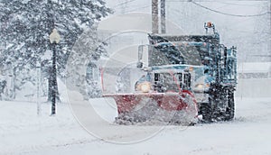 Snow plow working during a blizzard