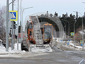 A snow plowman clearing the streets of snow after a blizzard