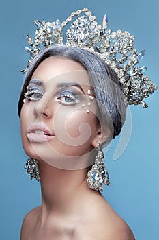 Snow Queen.Fantasy girl portrait. Winter fairy portrait.Young woman with creative silver artistic make-up.
