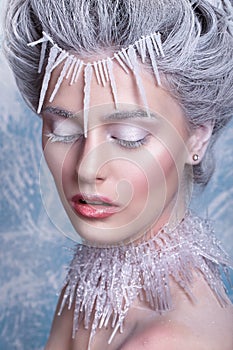 Snow Queen.Fantasy girl portrait. Winter fairy portrait.Young woman with creative silver artistic make-up. Winter Portrait.