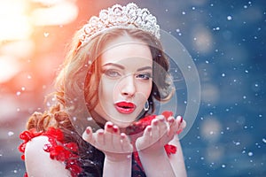 Snow Queen in red. Winter woman in crown in a red dress and red