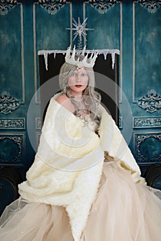 Snow queen wrapped in fur cloak