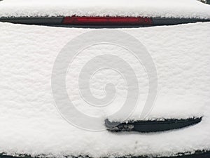 Snow on the rear window of the car. ar rear window in the snow