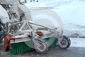 Snow removal equipment attached to tractor. Rear view, close-up