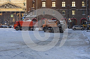 Snow removal equipment clears the city from the fallen snow