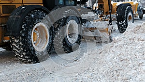 Snow removal equipment on snow-covered road in winter. Snow blower removing snow from road