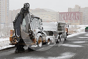 Snow removal equipment standing in the yard under the snow