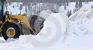 Snow removal with loader machinery after blizzard photo