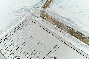 snow removal from a tiled footpath, overhead view