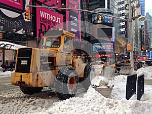 Snow Removal Tractor on Times Square in Snow in Winter.