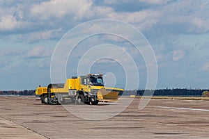 Snow removal vehicles in the airport. Snow plow trucks. Airport maintaining machinery. Training snow plow operators before winter