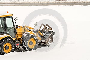 Snow removal. Wheel loader machine or vehicle removing snow from the roads