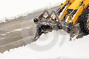 Snow removal. Wheel loader machine or vehicle removing snow from the roads