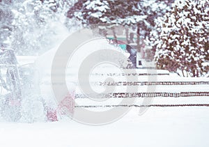 Snow-removal work with a snow blower. Man Removing Snow. heavy precipitation and snow piles.