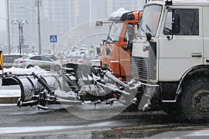 Snow removing equipement in the street in blizzard.