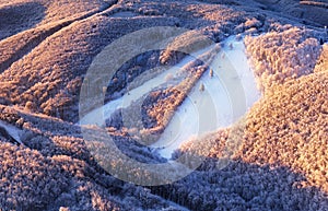 Snow on ski slope at ski resort on a sunny winter day