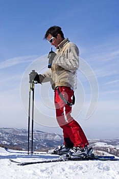Snow Skier with walkietalkie over blue Sky photo