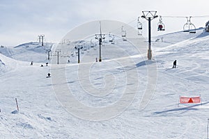 Snow slopes and chairlifts at Parnassos ski resort in Greece on a sunny winter day