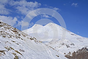 Snow at the slopes of North Caucasus and two-headed Mount Elbrus