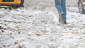 Snow slush on road, thaw. Pedestrians get stuck in snow, wet shoes