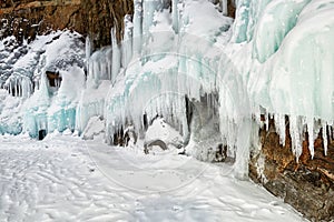 Snow on splashed ice on coastal rock