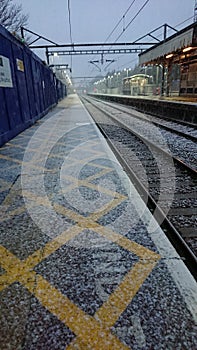 Snow starting to fall on train tracks at seven kings station