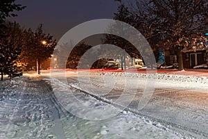 Snow on street and Highway during December 2016, icy road winter storm, in urban area at night