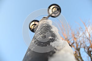 Snow on streetlamp