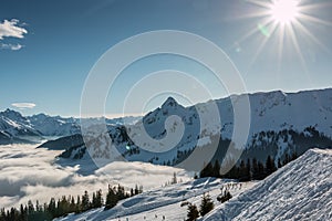 Snow and sun on the top of the mountains and fog down the valley