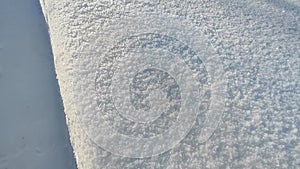 Snow texture. Snow path in the garden. Tunnel in a snowdrift