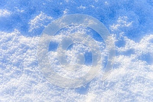 Snow texture at sunny winter day. Abstract background