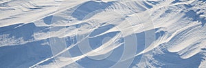 Snow texture. Wind sculpted patterns on snow surface