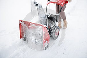 Snow thrower machine in work