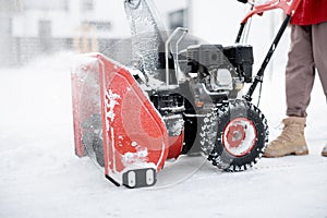 Snow thrower machine in work