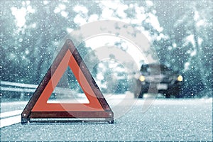 Snow time black car have accident park on road. Red triangle, red emergency stop sign, red emergency symbol and black car stop and