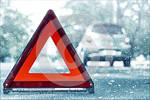 Snow time black car have accident park on road. Red triangle, red emergency stop sign, red emergency symbol and black car stop and