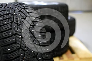 Snow tires with metal studs in garage