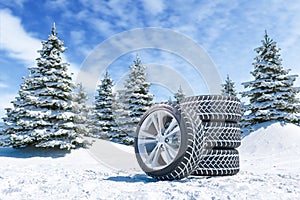 Snow tires on winter landscape background