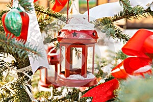 Snow tree decorated with red candlestick, toys and tapes