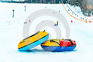 snow tubing rings close up. hill on background